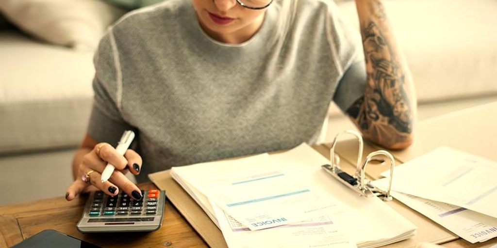 person calculating finances at home office